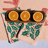 Holly Toss on Blush Dinner Napkins