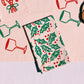 Holly Toss on Blush Dinner Napkins