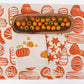 Orange Gourds on Oatmeal Runner